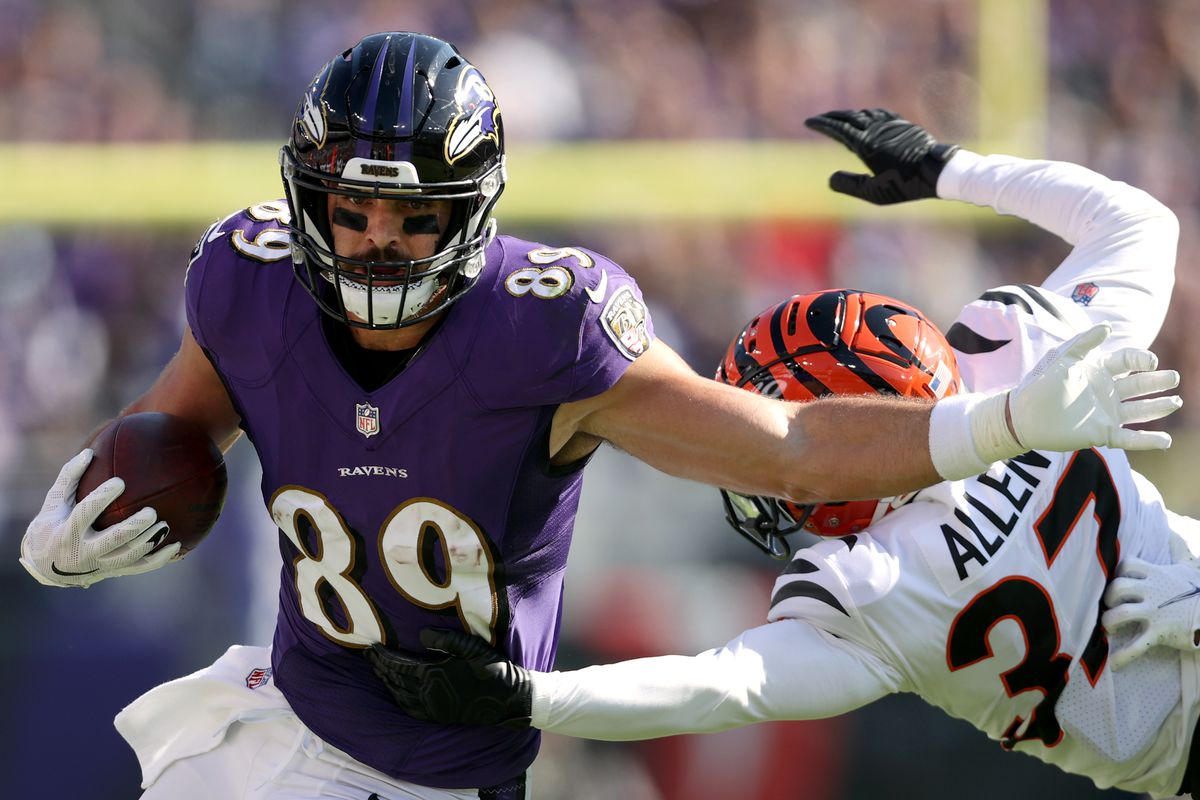 Mark Andrews #89 of the Baltimore Ravens runs with the ball as Ricardo Allen #37 of the Cincinnati Bengals defends during the first half in the game at M&amp;T Bank Stadium on October 24, 2021 in Baltimore, Maryland.