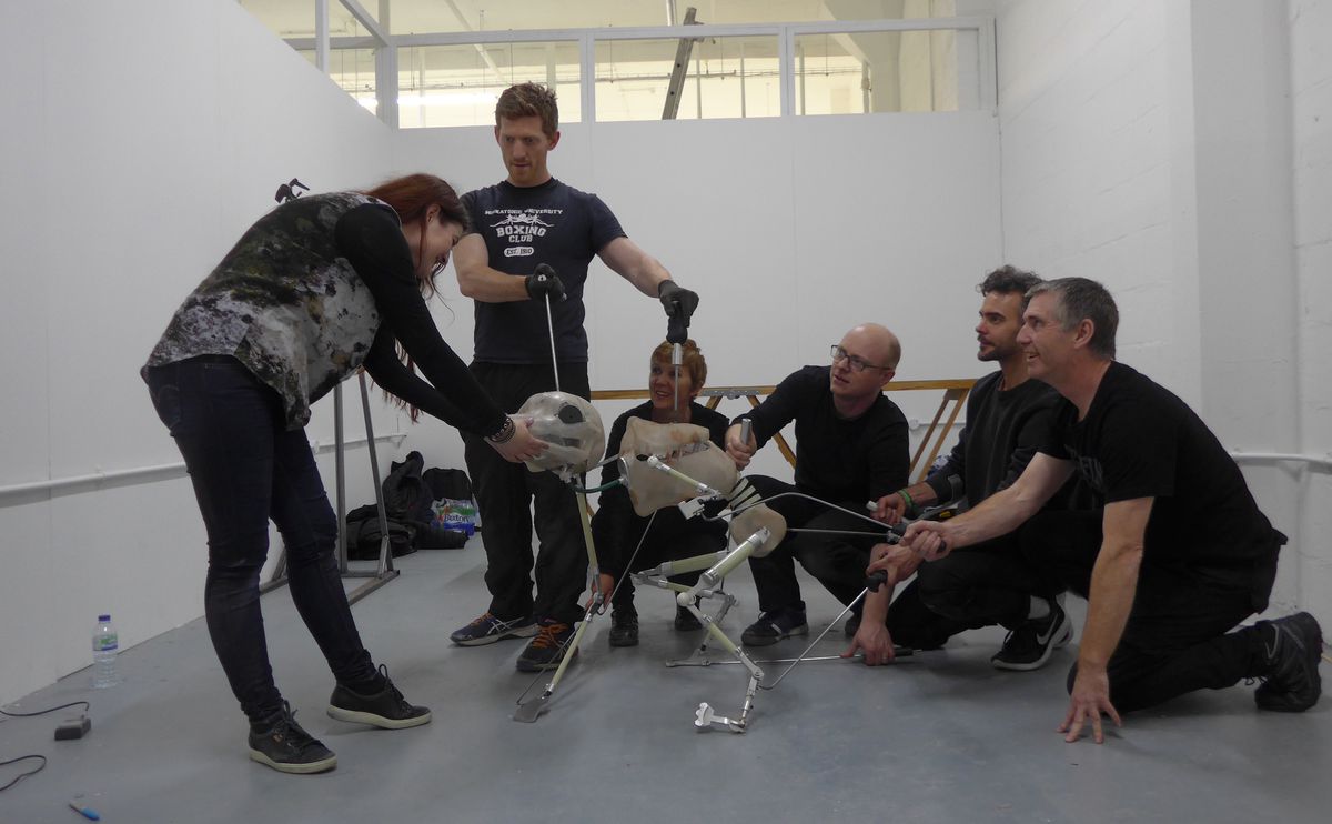 Director Hanna Bergholm studies the bones and initial build of the Alli puppet, as puppeteers&nbsp;Robin Guyver, Lynn Robertson Bruce, Colin Purves, Tom Wilton and lead creature puppeteer Phill Woodfine demonstrate its function. Behind the scenes on Hatching.