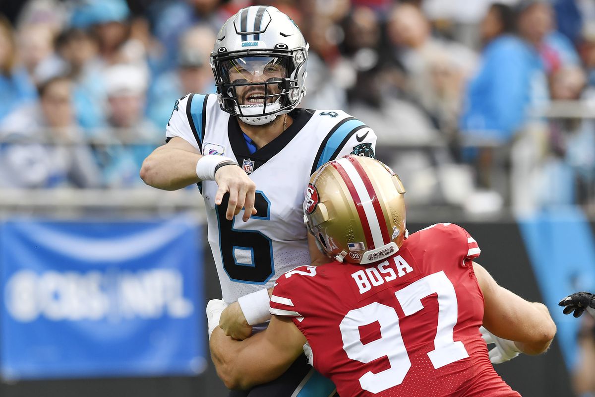 Baker Mayfield #6 of the Carolina Panthers is tackled by Nick Bosa #97 of the San Francisco 49ers during the first half of the game at Bank of America Stadium on October 09, 2022 in Charlotte, North Carolina.