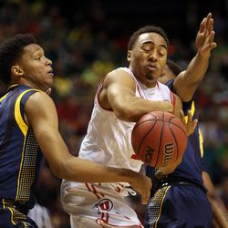 Utah Utes guard Brandon Taylor, center, loses control of the ball while being defended during the Pac-12 conference tournament semifinal against the Cal Bears at the MGM Grand Garden Arena in Las Vegas, Friday, March 11, 2016.