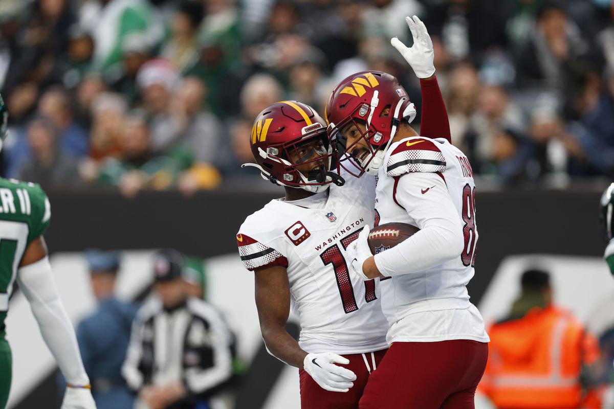 Logan Thomas of the Washington Commanders celebrates a third quarter touchdown with Terry McLaurin during a game against the New York Jets at MetLife Stadium on December 24, 2023 in East Rutherford, New Jersey.