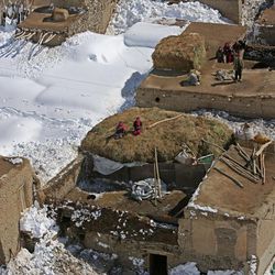 Afghans sit on the rooftops of their homes damaged in an avalanche, in the Paryan district of Panjshir province, north of Kabul, Afghanistan, Friday, Feb. 27, 2015. The death toll from severe weather that caused avalanches and flooding across much of Afghanistan has jumped to more than 200 people, and the number is expected to climb with cold weather and difficult conditions hampering rescue efforts, relief workers and U.N. officials said Friday. 