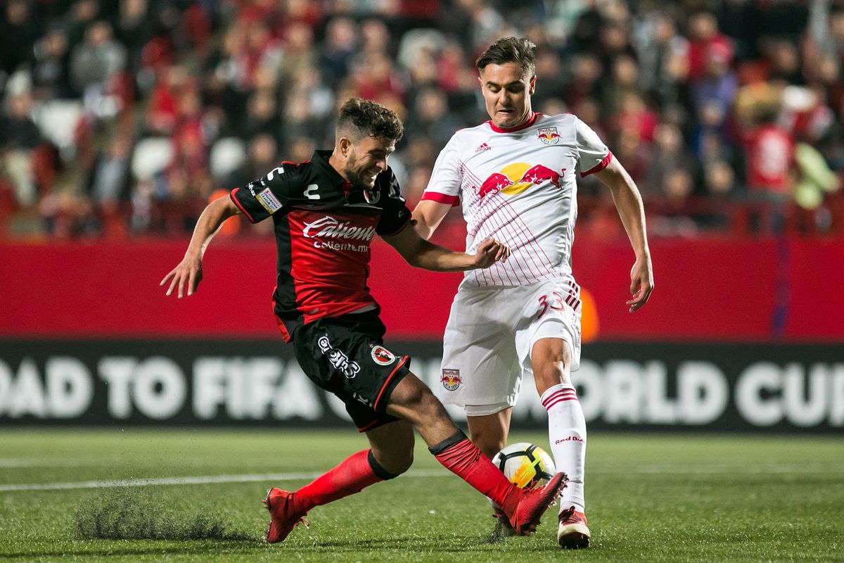 Club Tijuana’s José Alberto García fights for the ball against the New York Red Bulls’ Aaron Long in the quarterfinal round of the 2018 Concacaf Champions League.