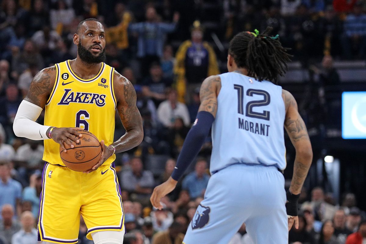 MEMPHIS, TENNESSEE - APRIL 26: LeBron James #6 of the Los Angeles Lakers handles the ball against Ja Morant #12 of the Memphis Grizzlies during the first half of Game Five of the Western Conference First Round Playoffs at FedExForum on April 26, 2023 in Memphis, Tennessee.