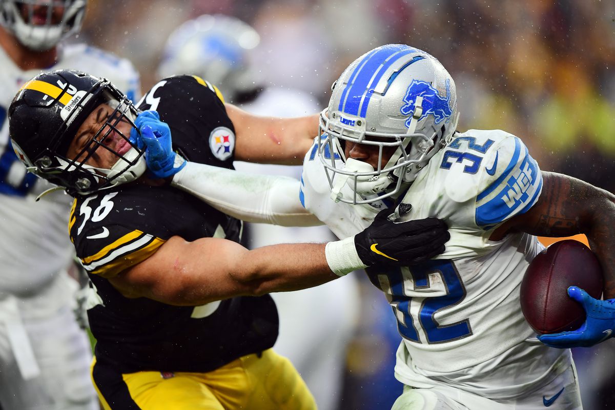 D’Andre Swift #32 of the Detroit Lions stiff arms Alex Highsmith #56 of the Pittsburgh Steelers during the fourth quarter at Heinz Field on November 14, 2021 in Pittsburgh, Pennsylvania.