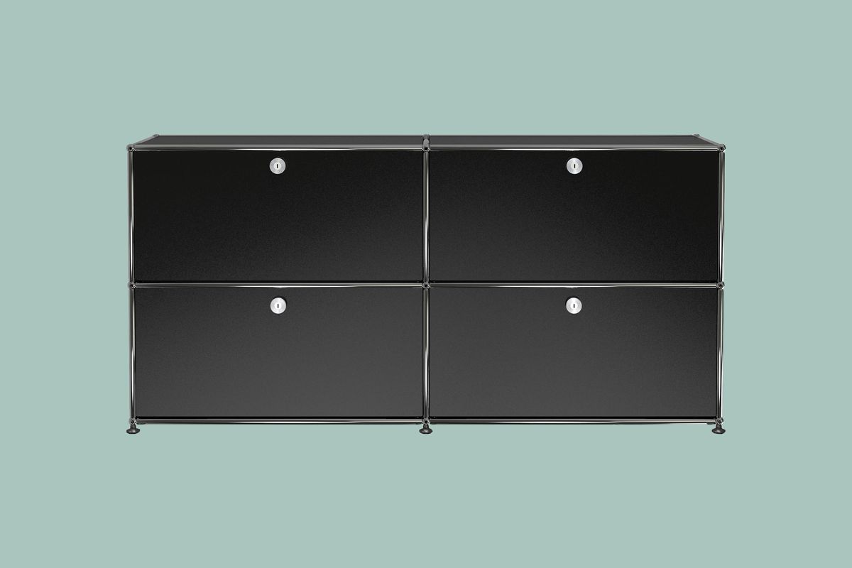 Black dresser with two rows of two compartments with silver edging and finishes. 
