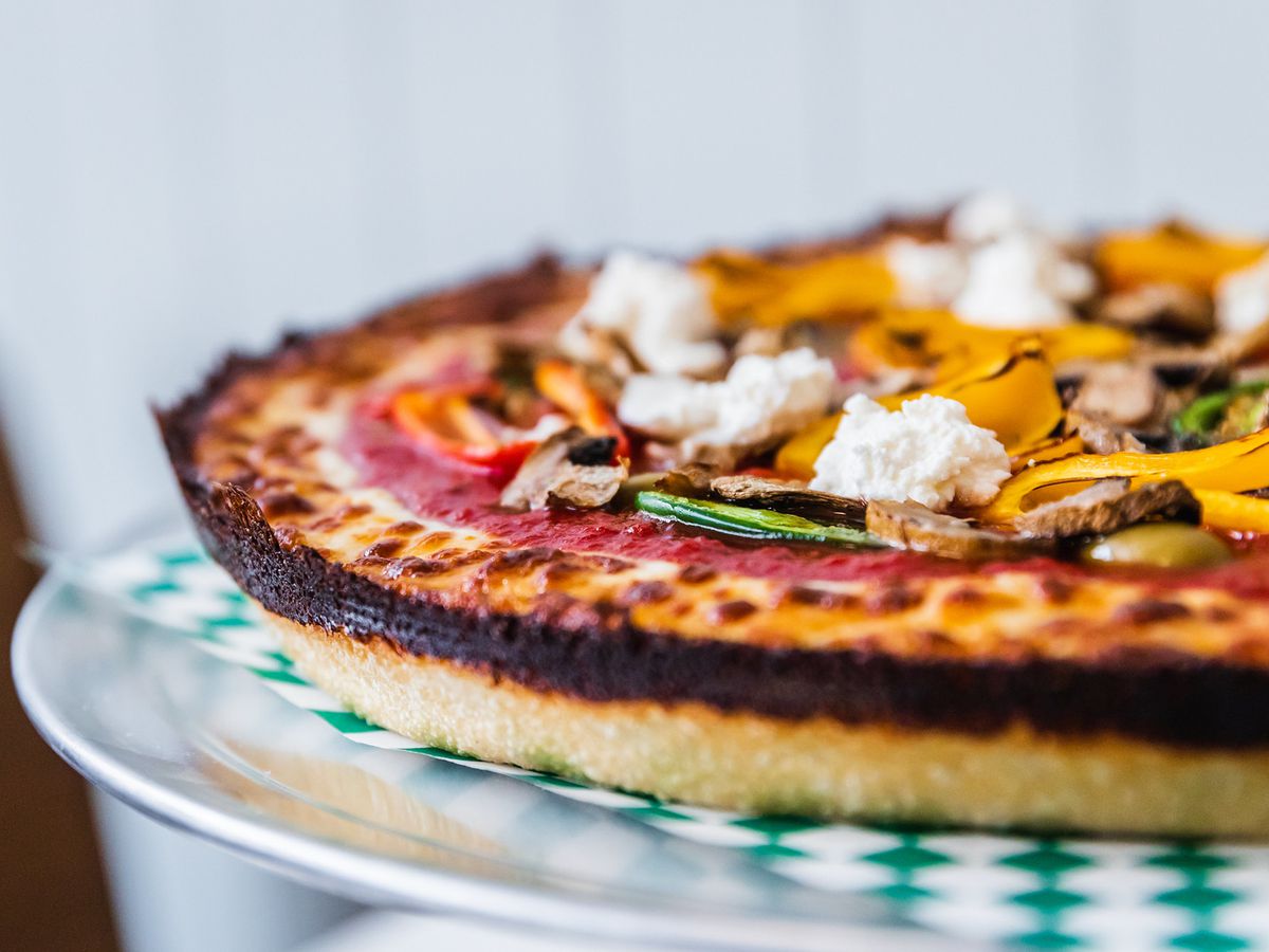 A deep dish pizza with crispy outer ring.