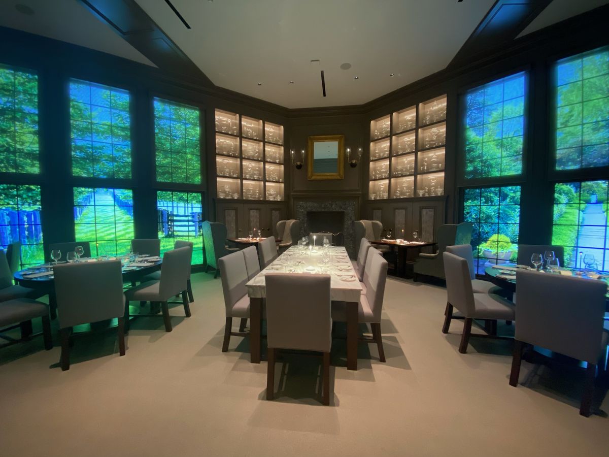 A dining room with LED screens made to look like windows