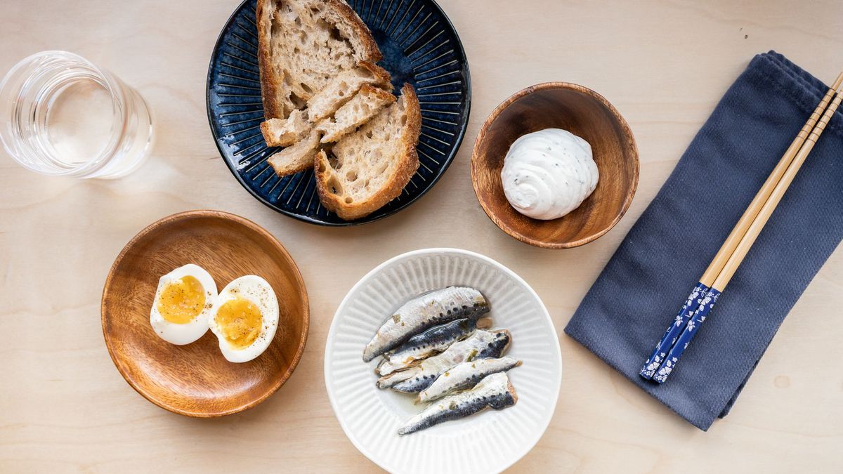 Sardines with boiled eggs, herb cream cheese, and levain.