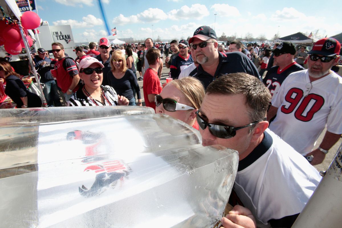 Football Fans drink from an ice luge at a tailgate prior to the Texans hosting the Cincinnati Bengals during their 2012 AFC Wild Card Playoff game at Reliant Stadium last week.  (Photo by Bob Levey/Getty Images)