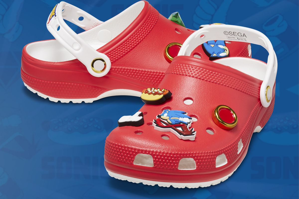 A Stock photo of the red Sonic-themed crocs on a blue background