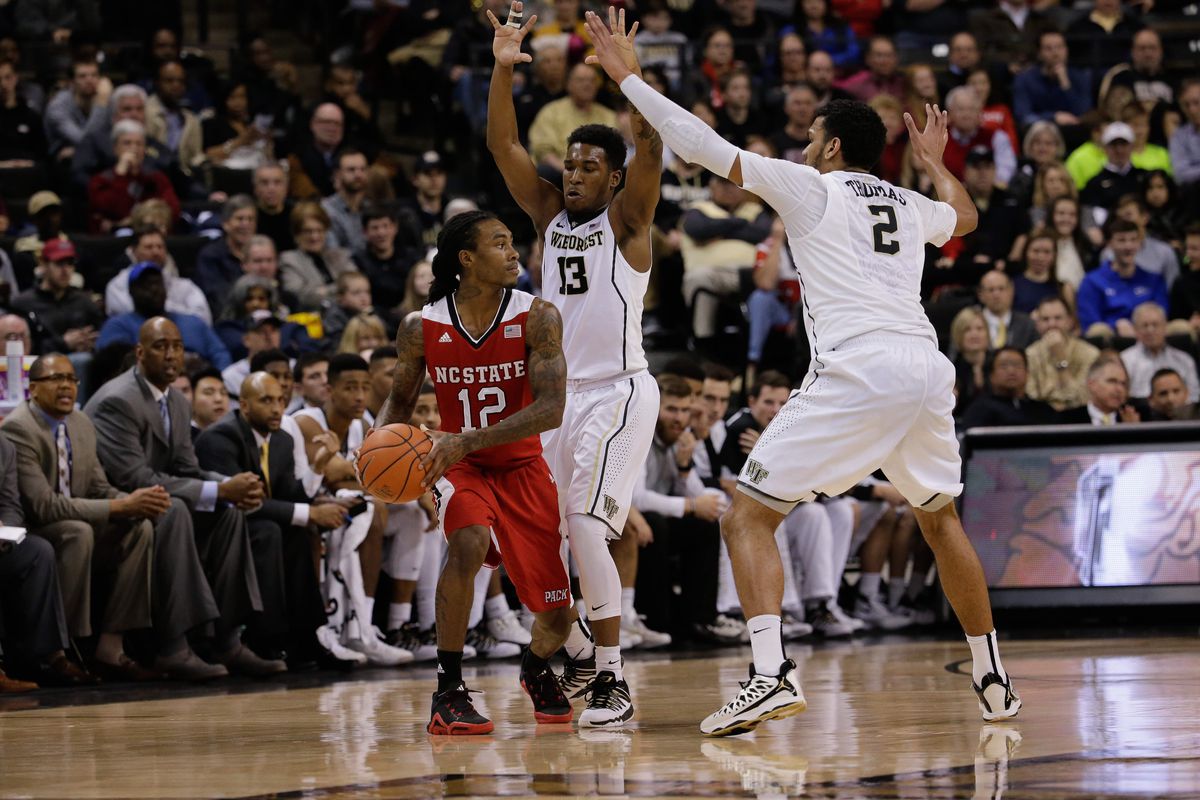 Bryant Crawford (13) and Devin Thomas (2) set a trap on NC State's Cat Barber