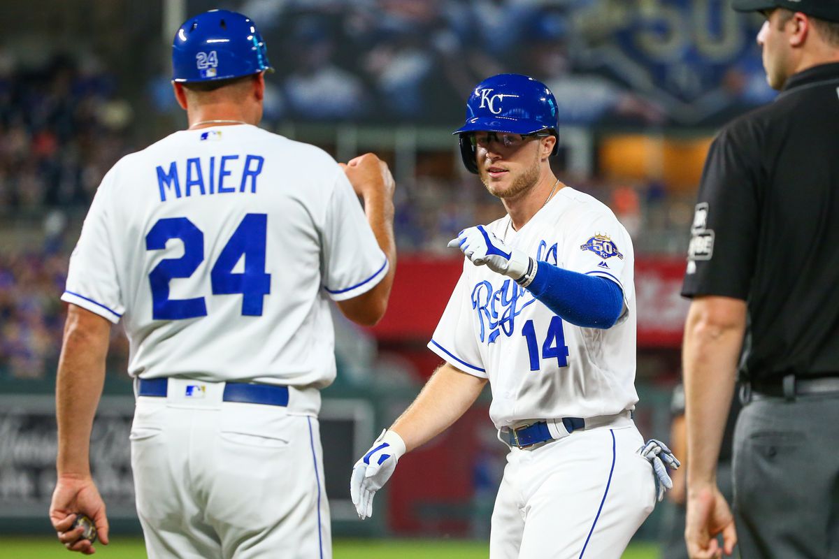 Kansas City Royals right fielder Brett Phillips (14) is congratulated by first base coach Mitch Maier (24) in the game against the Chicago Cubs at Kauffman Stadium.