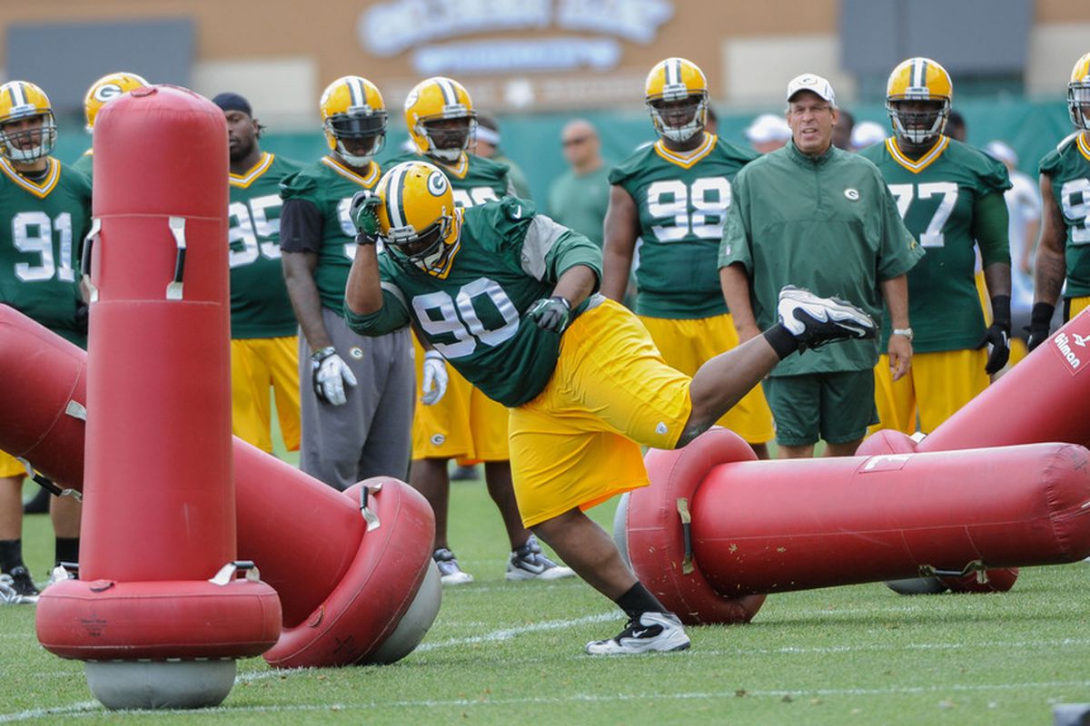 June 12, 2012; Green Bay, WI, USA;   Green Bay Packers defensive tackle B.J. Raji (90) works on a drill during the team's mandatory minicamp at Ray Nitschke Field.  Mandatory Credit: Benny Sieu-US PRESSWIRE