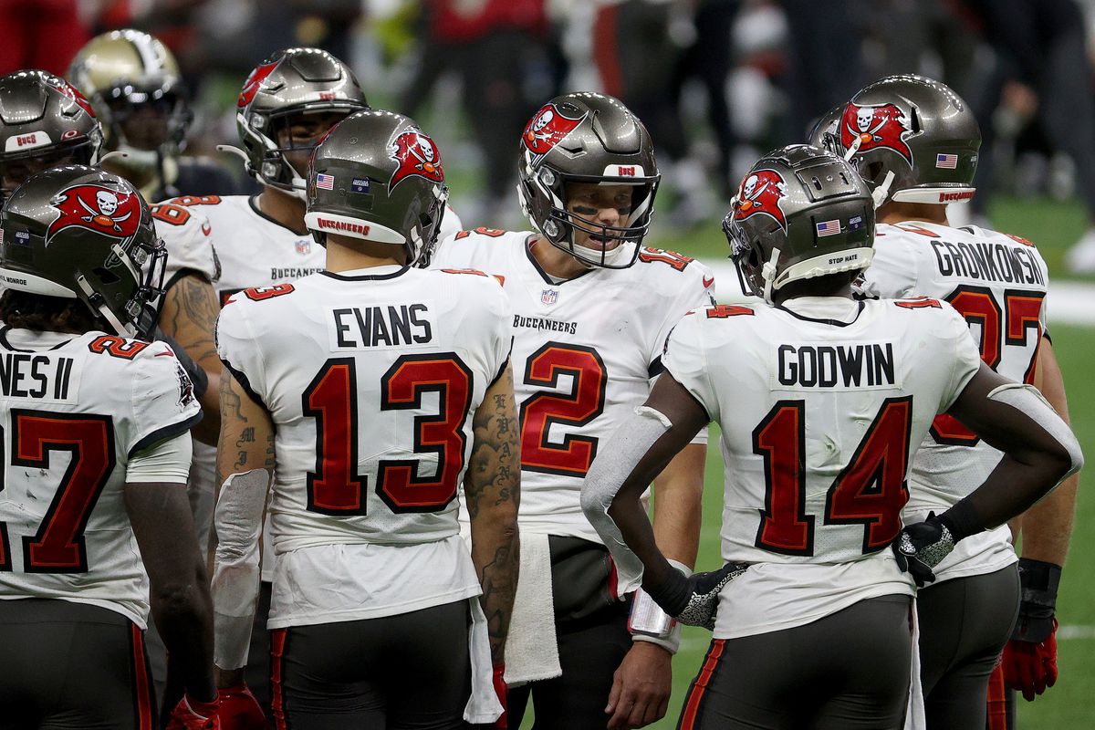 Tom Brady #12 of the Tampa Bay Buccaneers talks with his team in a huddle against the New Orleans Saints during the third quarter in the NFC Divisional Playoff game at Mercedes Benz Superdome on January 17, 2021 in New Orleans, Louisiana.