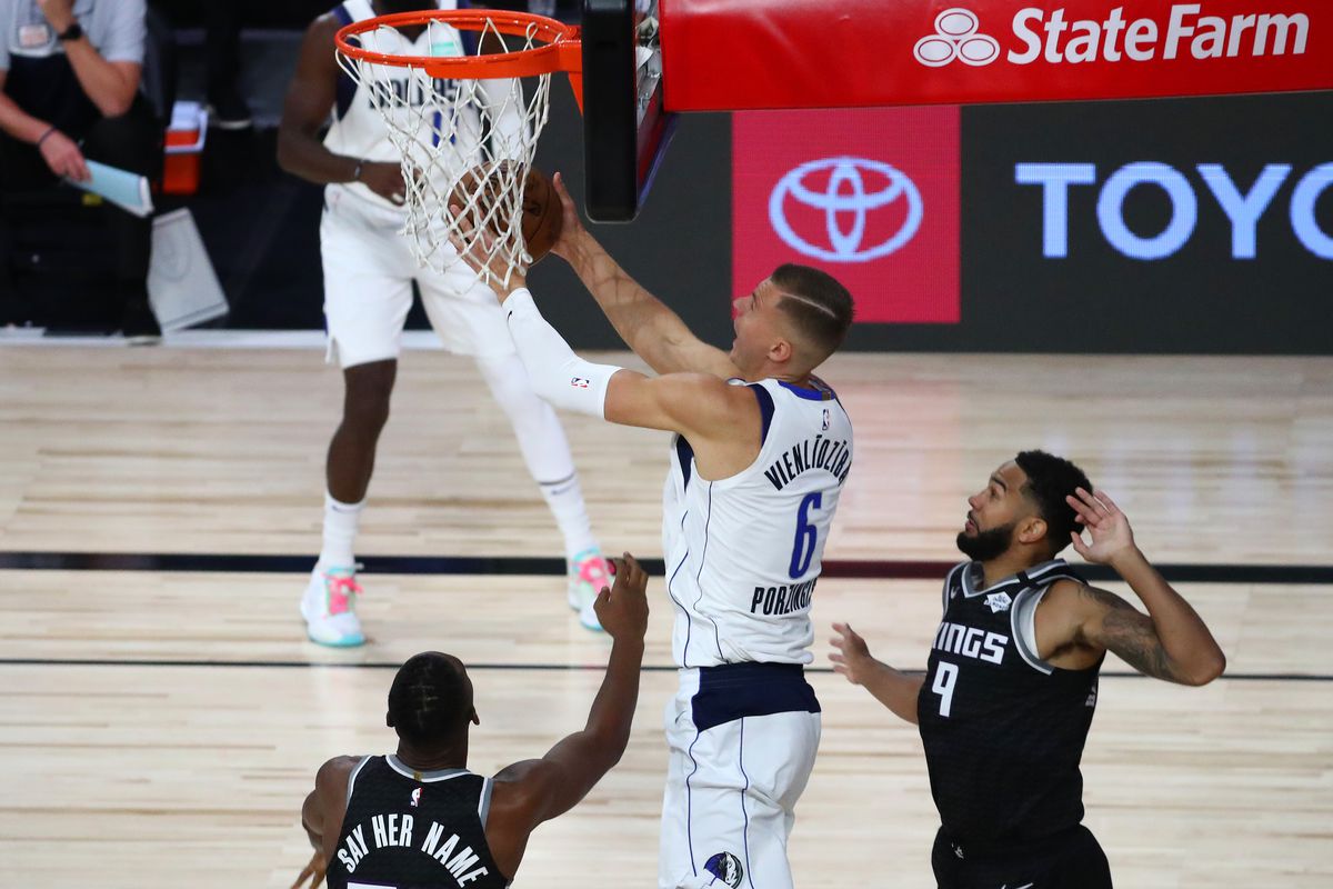 Dallas Mavericks forward Kristaps Porzingis shoots against Sacramento Kings center Harry Giles III and guard Cory Joseph in the first half of a NBA basketball game in the HP Field House at the ESPN Wide World of Sports Complex.&nbsp;