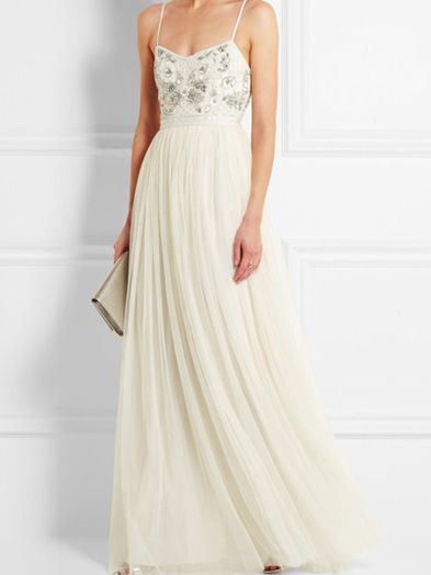 Model in ivory wedding dress with embroidered top detailing.
