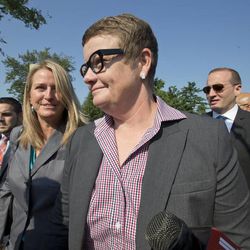 Plaintiffs in the California Proposition 8 case, Kris Perry, center, and her partner Sandy Stier, left, both from Berkeley, Calif., arrive at the Supreme Court in Washington, Tuesday, June 25, 2013, as key decisions are expected to be announced. Other plaintiffs in the case are Jeff Zarrillo, far left. At far right is Chad Griffin,  president of the Human Rights Campaign. (AP Photo/J. Scott Applewhite)