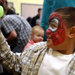 Bryant Lega makes an egg flower at Make-A-Wish Utah's annual Easter egg hunt for children facing life-threatening medical conditions at the Discovery Gateway Museum in Salt Lake City on Saturday, March 19, 2016. 