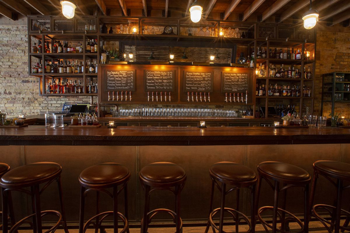 A wooden bar with beer menus in Chicago.