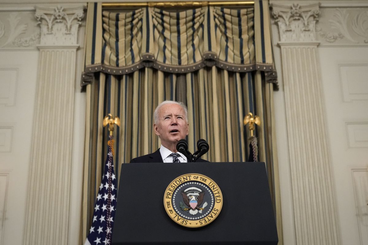 President Joe Biden speaks from behind a lectern.