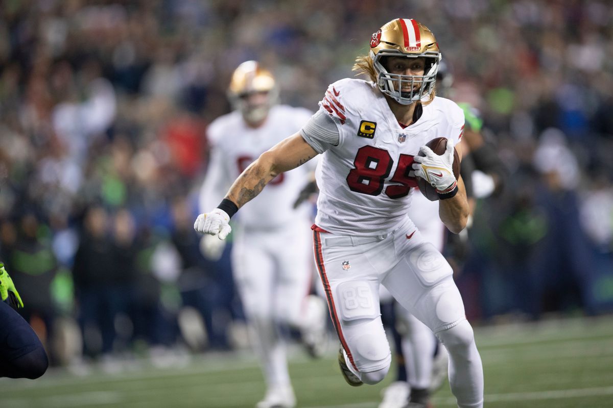 George Kittle #85 of the San Francisco 49ers head to the end zone on a 28-yard touchdown catch during the game against the Seattle Seahawks at Lumen Field on December 15, 2022 in Seattle, Washington. The 49ers defeated the Seahawks 21-13.