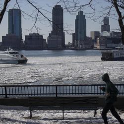 Ice flows pass through New York Harbor, Friday, Feb. 20, 2015, in New York. Arctic air and bitterly cold wind is moving across the Northeast, plunging temperatures into record low single digits, accompanied by subzero wind chills. 