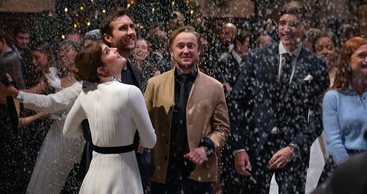 Emma Watson, Matthew Lewis, and Tom Felton stand in artificial falling snow in the Return to Hogwarts special
