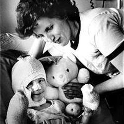 Gina Taylor, 5, shares a smile with her mother, Jane Taylor, in the hospital in Logan in 1986 following the Cokeville school bombing.