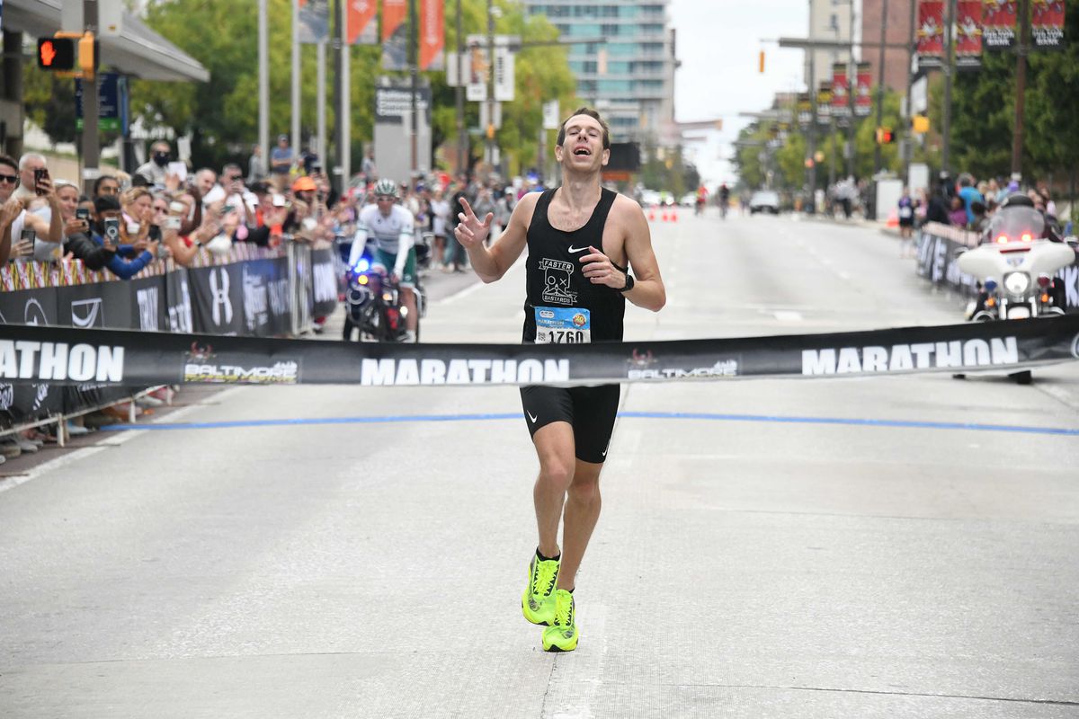 Jeremy Ardanuy crosses the finish line of the marathon portion of the Baltimore Running Festival on Saturday, Oct. 9, 2021, winning with a time of 2:26:49.