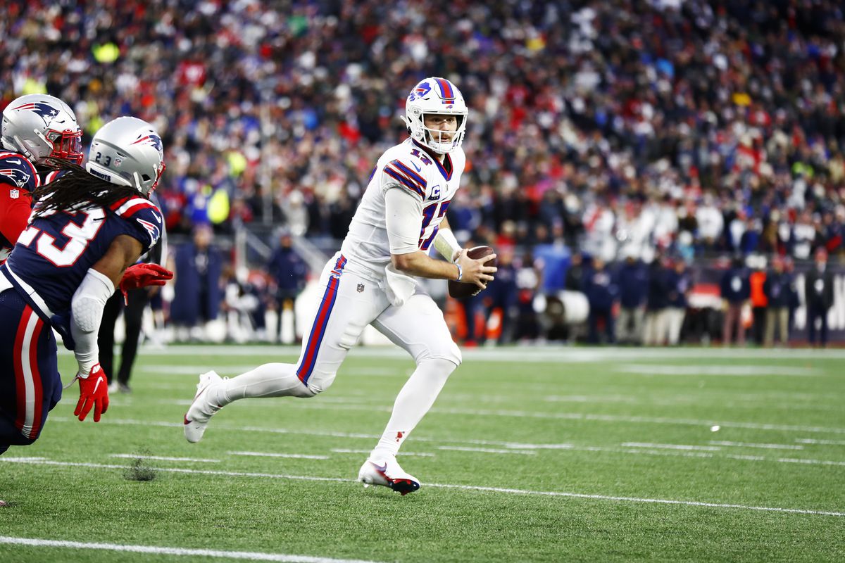 Quarterback Josh Allen #17 of the Buffalo Bills rolls out to his left during the fourth quarter of the game against the New England Patriots at Gillette Stadium on December 26, 2021 in Foxborough, Massachusetts.