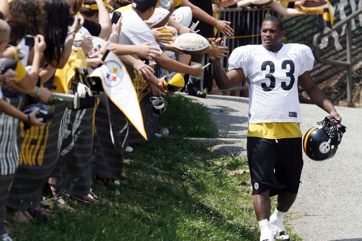July 28, 2012; Pittsburgh, PA, USA; Pittsburgh Steelers running back Isaac Redman (33) interacts with fans on his way to the field during training camp at Saint Vincent College. Mandatory Credit: Charles LeClaire-US PRESSWIRE