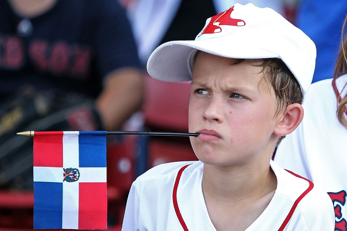 (Boston, MA, 07/29/15) A young fan holds the Dominican flag in his mouth as former Red Sox pitcher Pedro Martinez is honored with his number being retired before the MLB game against the Chicago White Sox at Fenway Park on Wednesday, July 29, 2015