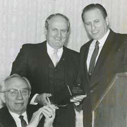 BYU head football coach LaVell Edwards is honored by Elder Thomas S. Monson, now president of The Church of Jesus Christ of Latter-day Saints, and Elder Gordon B. Hinckley on Dec. 13, 1984.
