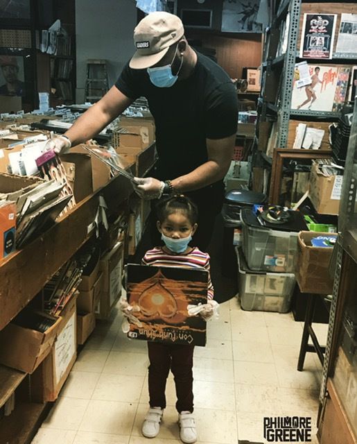 Chicago rapper Philmore Greene looks for vinyl records with his daughter, Cadence.