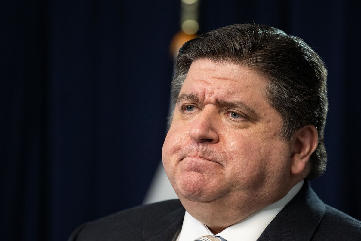 Gov. J.B. Pritzker listens at a COVID-19 news conference in March.