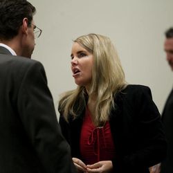 Attorneys Susanne Gustin, center, and Randy Spencer, left, speak during a brief break in the trial of their client Martin MacNeill, right, at 4th District Court in Provo Wednesday, Oct. 30, 2013. MacNeill is charged with murder for allegedly killing his wife, Michele MacNeill, in 2007.