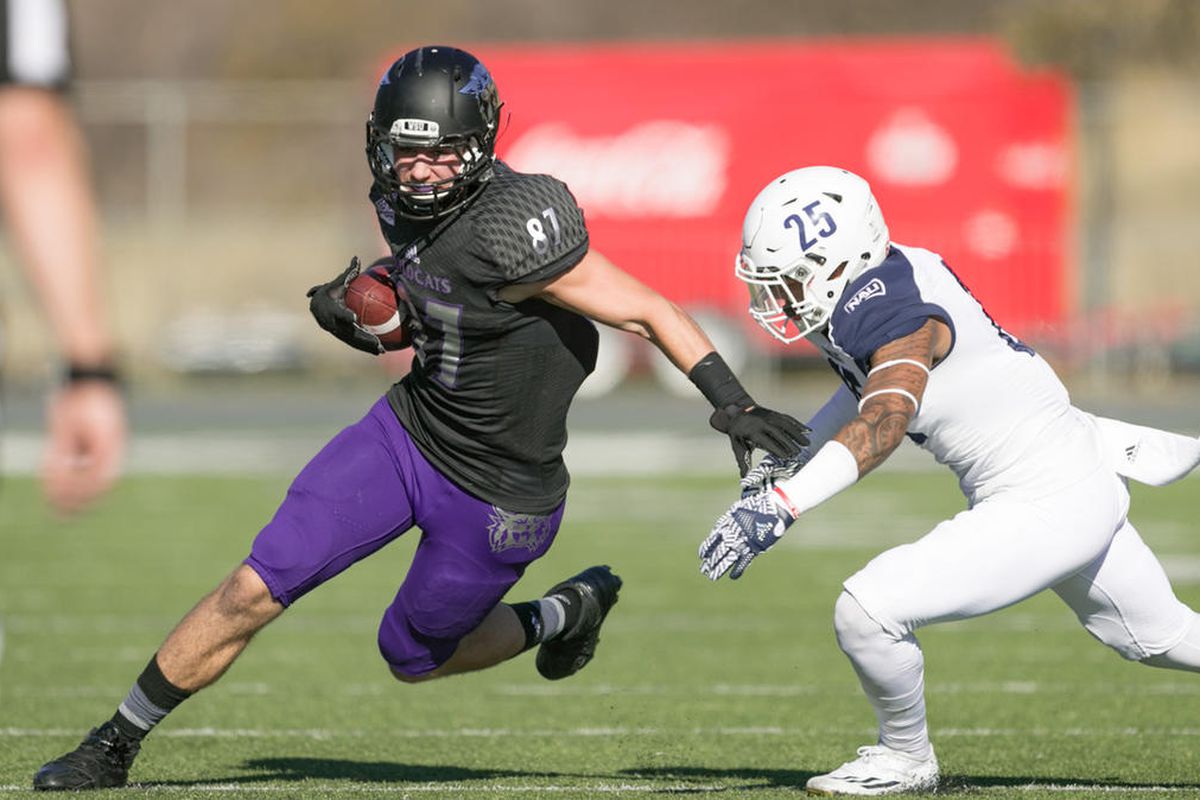 Weber State tight end Andrew Vollert (left-center) runs by a defender. He leads the Wildcats in receiving this season.