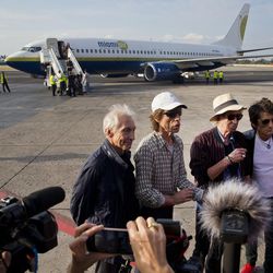 Members of The Rolling Stones, from left, Charlie Watts, Mick Jagger, Keith Richards and Ron Wood talk with the press after arriving to Jose Marti international airport in Havana, Cuba, Thursday, March 24, 2016. The Stones are performing a free concert in Havana on Friday, becoming the most famous act to play Cuba since its 1959 revolution. 