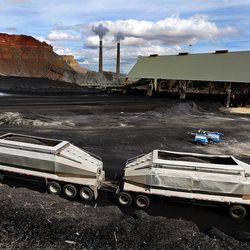 A truck arrives to dump coal at the Huntington power plant in Huntington on Tuesday, March 24, 2015. A new national energy report shows in serious declines in coal production, consumption and employment.