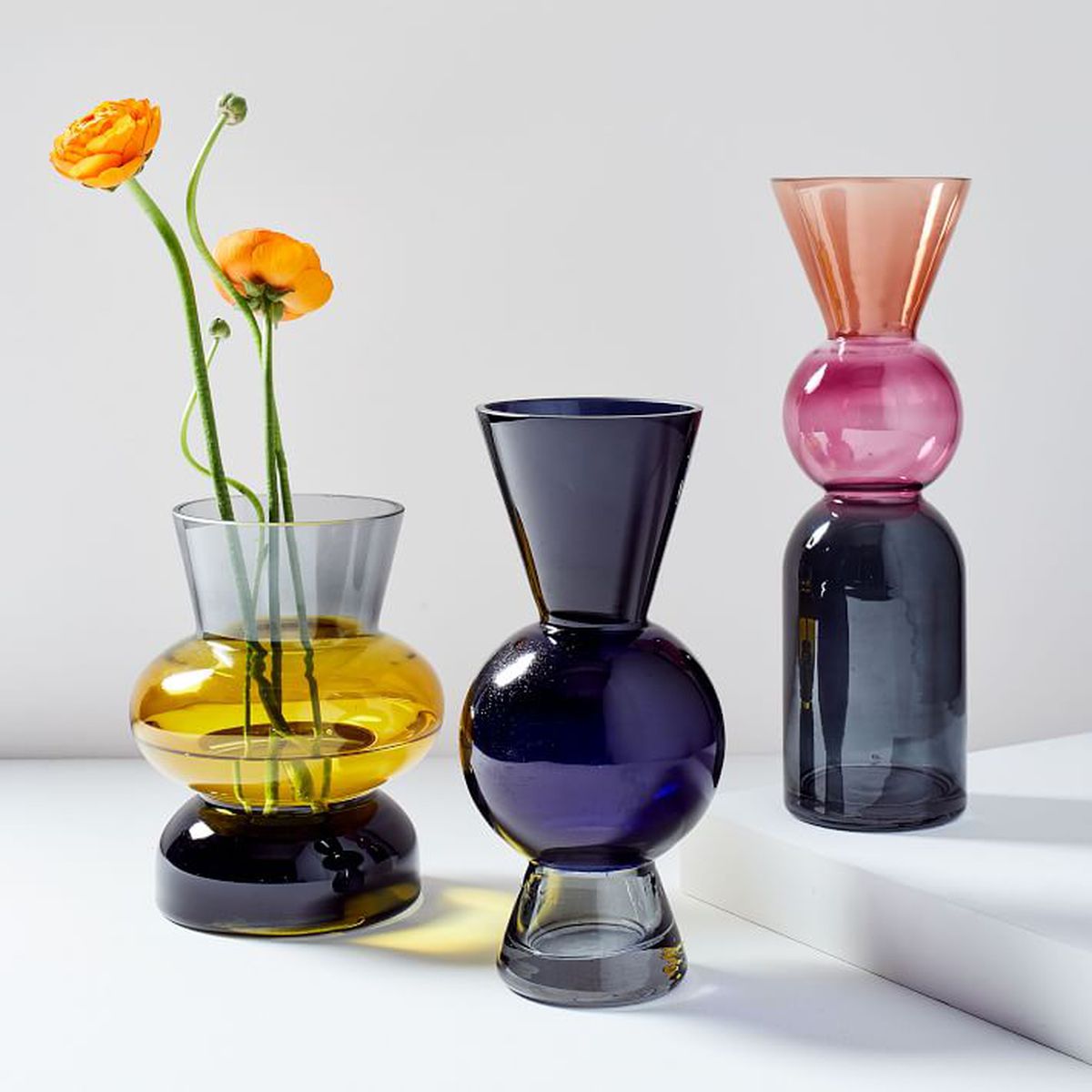 A trio of vases with different shapes and colors. 
