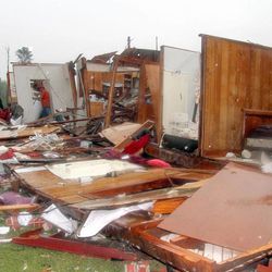 Family members and friends search through Ralph Sciple's home on Highway 397 in Kemper County, Miss., after a tornado ripped through the area Thursday, April 11, 2013. The Sciples were taken to a local hospital with minor injuries. A strong spring storm that socked the Midwest with ice and heavy, wet snow made its way east, raking the South with tornadoes Thursday, with three deaths blamed on the rough weather and thousands of people without power.  