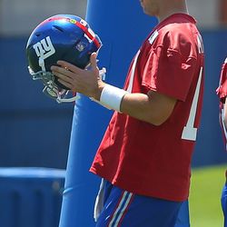 Eli Manning adjusts his helmet