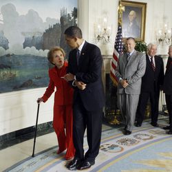 FILE - In this June 2, 2009, file photo, President Barack Obama escorts former first lady Nancy Reagan after signing the Ronald Reagan Centennial Commission Act, during a ceremony in the Diplomatic Reception Room of the White House in Washington. The former first lady has died at 94, The Associated Press confirmed Sunday, March 6, 2016. 