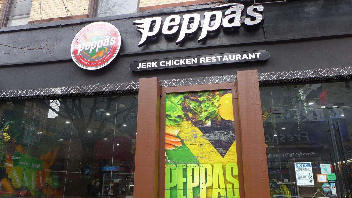 A gleaming storefront with Peppas in lower case, in the colors of black, yellow, and green.