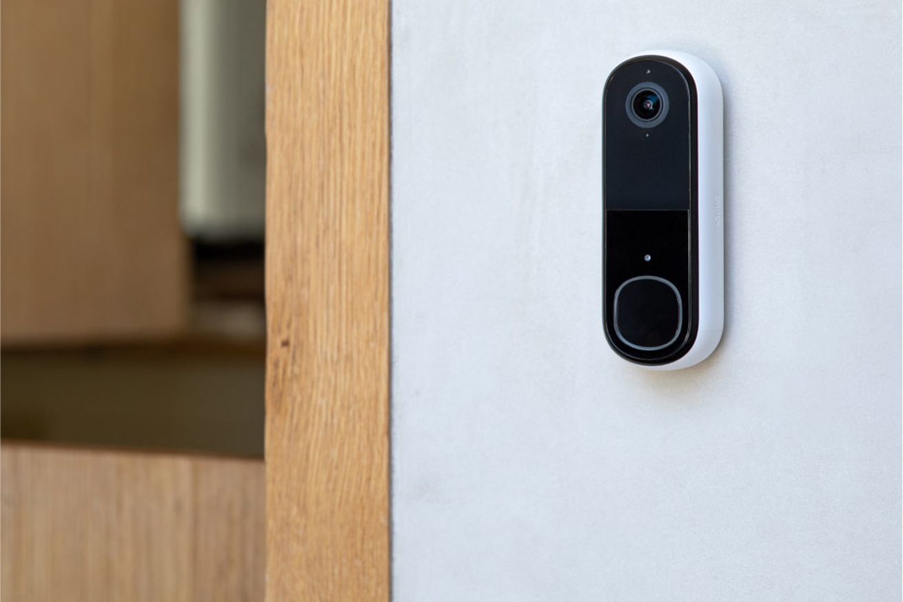 The Arlo Essential Doorbell second-gen on a door frame.