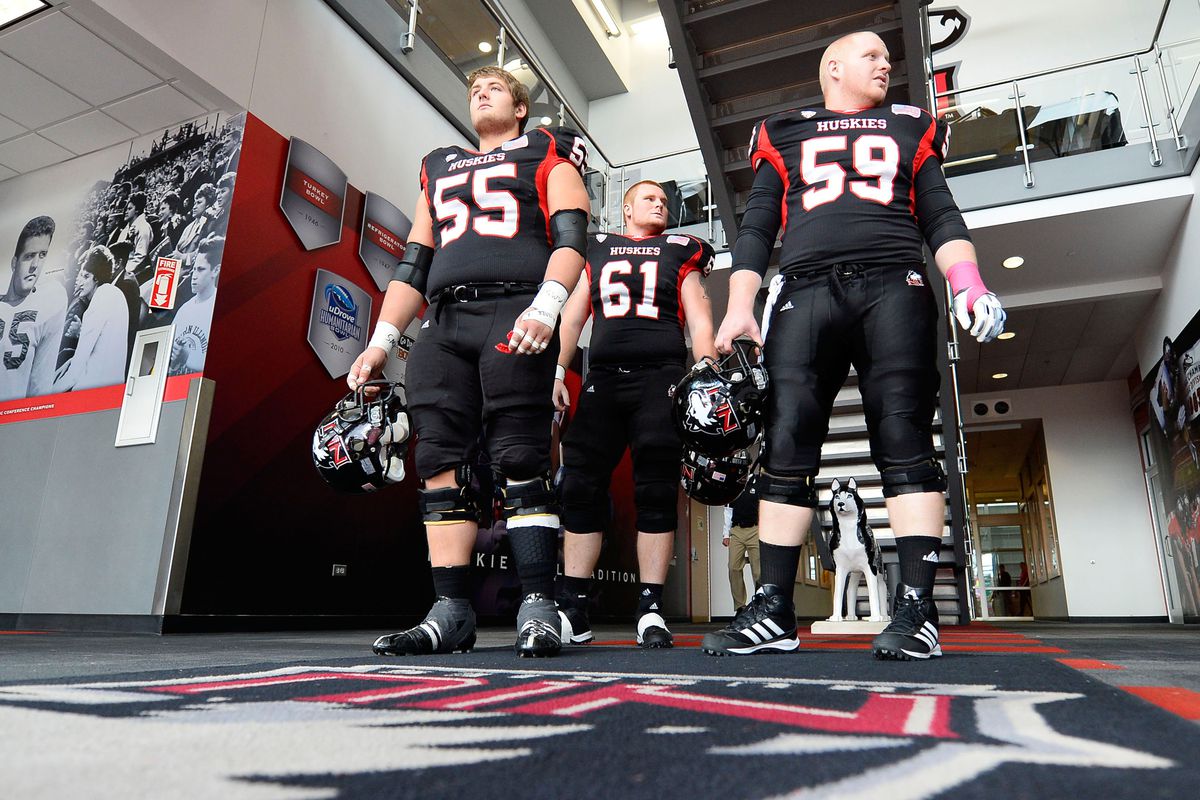 NIU offensive linemen Andrew Ness (55), Aidan Conlon (61) and Michael Gegner (59) wait to take the field last week against EMU