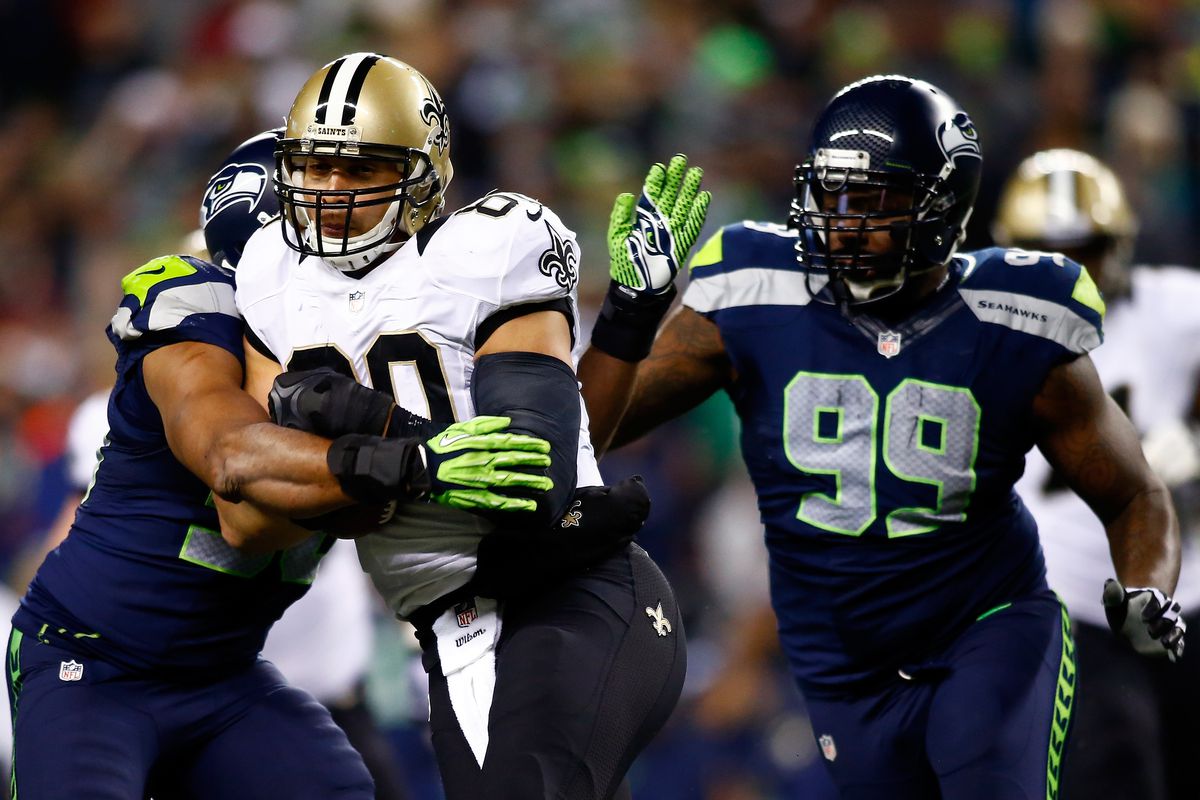SEATTLE, WA:  Seattle Seahawks defensive tackle Tony McDaniel (99) assists linebacker K.J. Wright (50) in stopping New Orleans Saints tight end Jimmy Graham (80) during a game at CenturyLink Field.