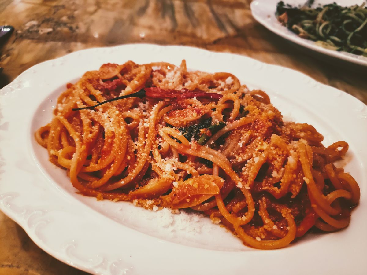 Spaghetti at Mother Wolf on a white plate.