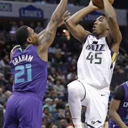 Utah Jazz's Donovan Mitchell (45) shoots over Charlotte Hornets' Treveon Graham (21) during the first half of an NBA basketball game in Charlotte, N.C., Friday, Jan. 12, 2018. (AP Photo/Chuck Burton)